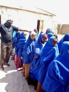 Jama Ahmed Mohamed with female students from the Kudhaa Primary School in Khudhaa, Somalia.